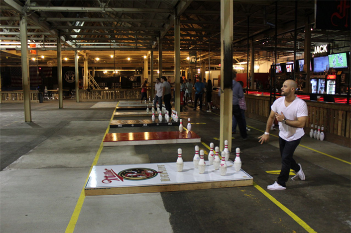 Guy throwing football at pins